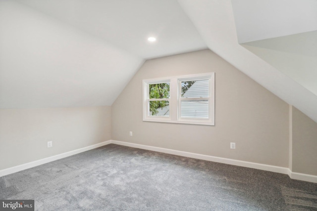 additional living space with lofted ceiling and carpet flooring