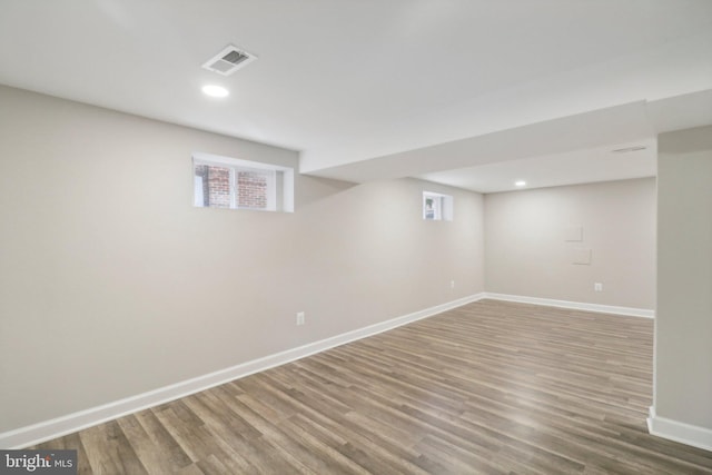 basement with hardwood / wood-style floors