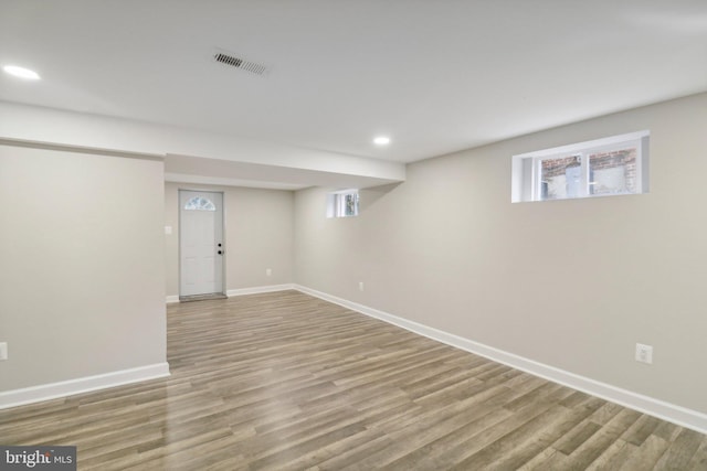 basement with hardwood / wood-style floors