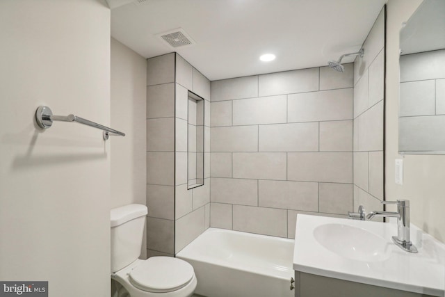 full bathroom featuring vanity, toilet, and tiled shower / bath