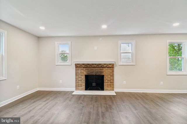 unfurnished living room featuring a fireplace and hardwood / wood-style floors