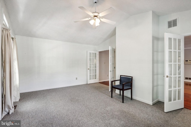 living area with french doors, carpet floors, vaulted ceiling, and ceiling fan