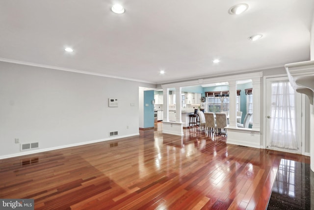 living room with wood-type flooring and ornamental molding