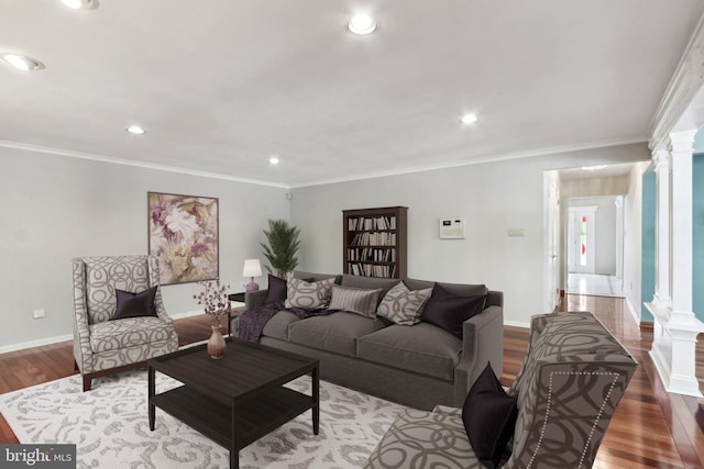 living room featuring ornamental molding, hardwood / wood-style flooring, and ornate columns