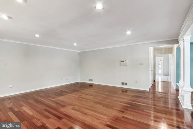 unfurnished room with ornate columns, ornamental molding, and dark wood-type flooring