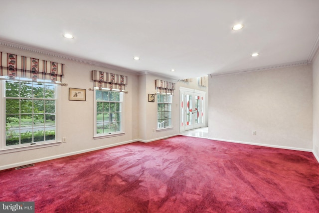 carpeted empty room featuring french doors and crown molding