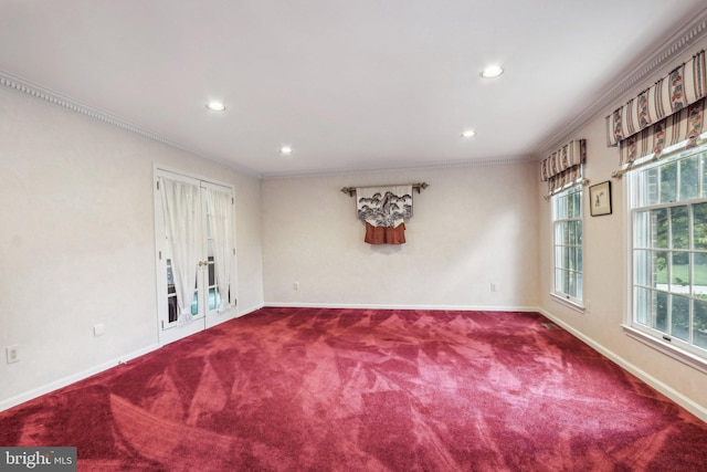 carpeted empty room featuring crown molding