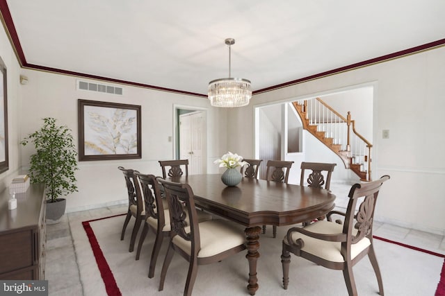 dining space with a notable chandelier and crown molding