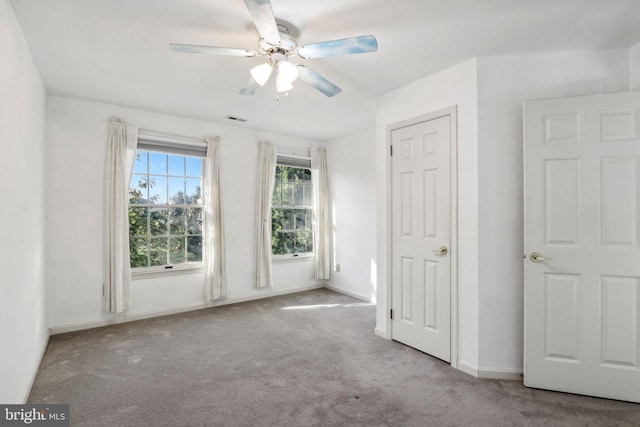 unfurnished bedroom featuring ceiling fan and light colored carpet