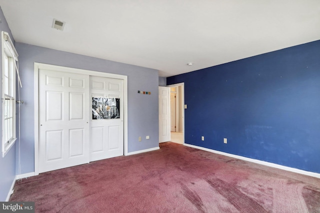 unfurnished bedroom with a closet and carpet