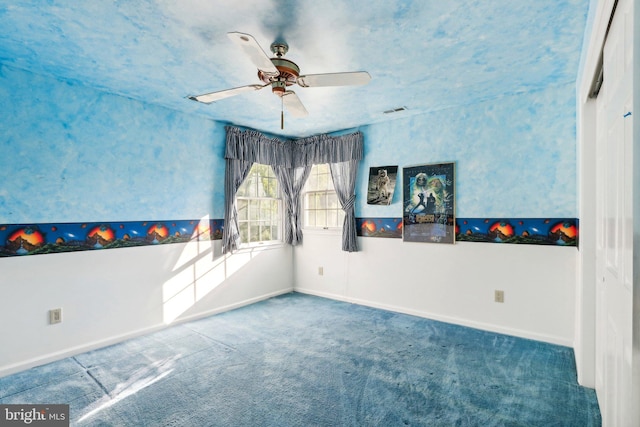 empty room featuring carpet and ceiling fan