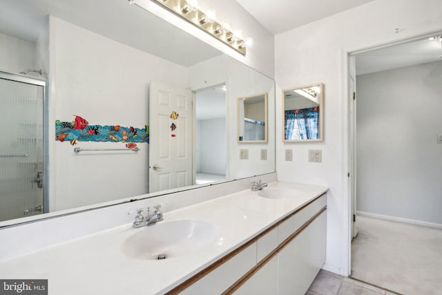 bathroom with walk in shower, vanity, and tile patterned flooring