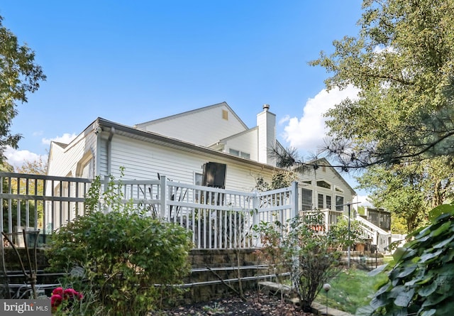 view of side of property featuring a wooden deck