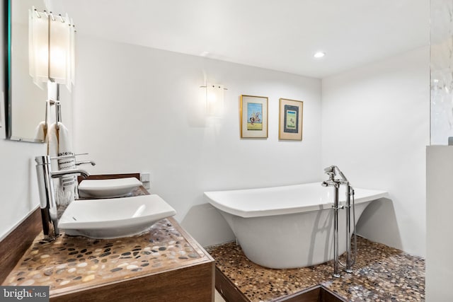 bathroom with sink and a washtub