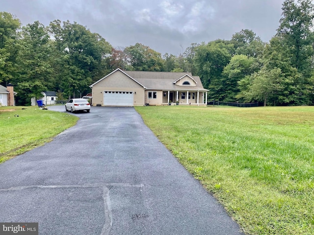 view of front of property with a garage and a front lawn