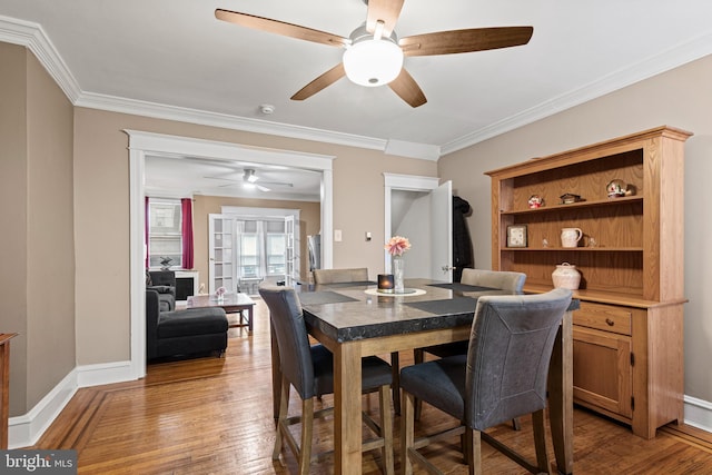 dining area featuring hardwood / wood-style floors, ceiling fan, and ornamental molding