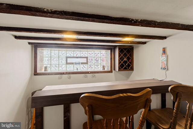 bar with beamed ceiling and plenty of natural light