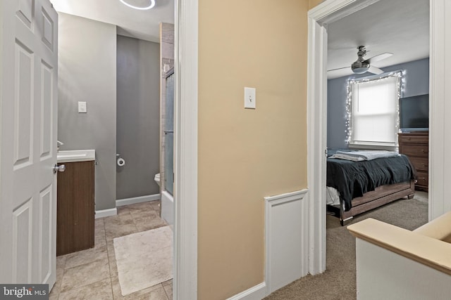 bathroom with tile patterned flooring, ceiling fan, enclosed tub / shower combo, and vanity