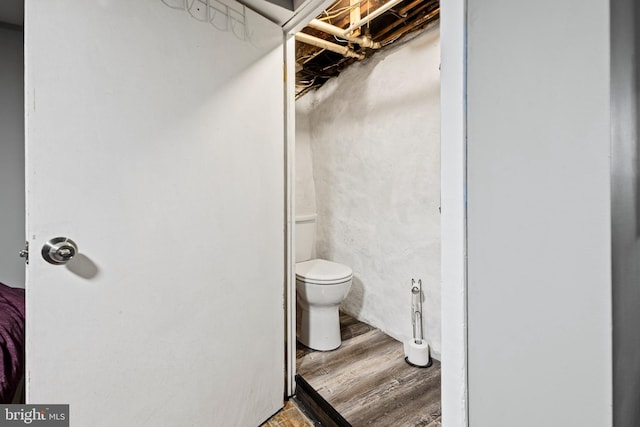 bathroom featuring wood-type flooring and toilet