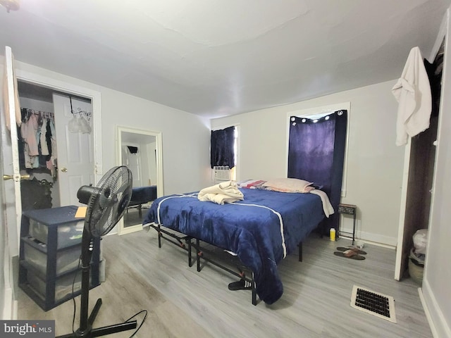 bedroom featuring a closet and light wood-type flooring