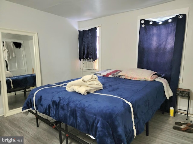 bedroom featuring cooling unit and wood-type flooring