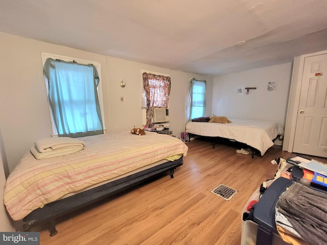 bedroom featuring cooling unit and hardwood / wood-style floors