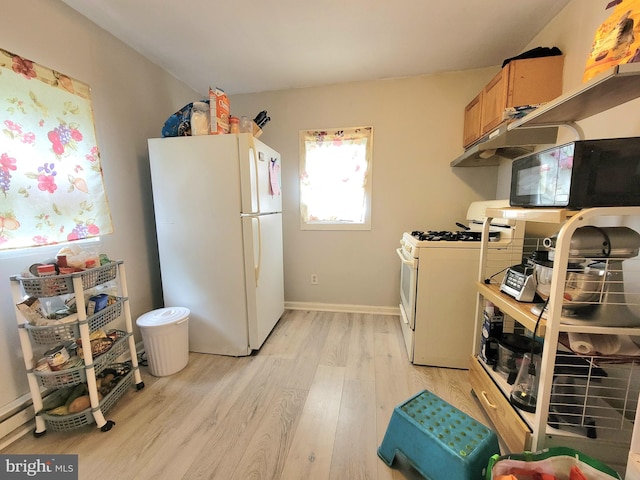 kitchen with light hardwood / wood-style floors and white appliances