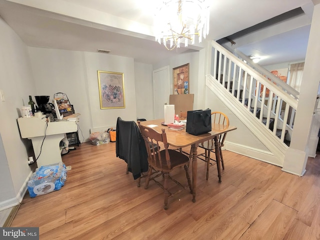 dining space with a chandelier and light wood-type flooring