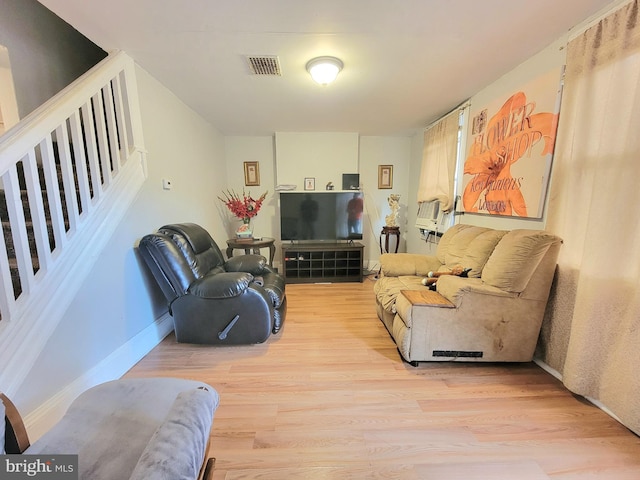 living room featuring cooling unit and light wood-type flooring