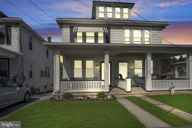 view of front of house with a lawn and covered porch