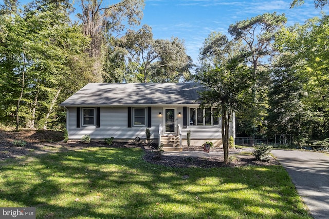 ranch-style home with a front lawn