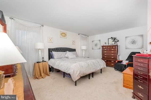 bedroom featuring light colored carpet