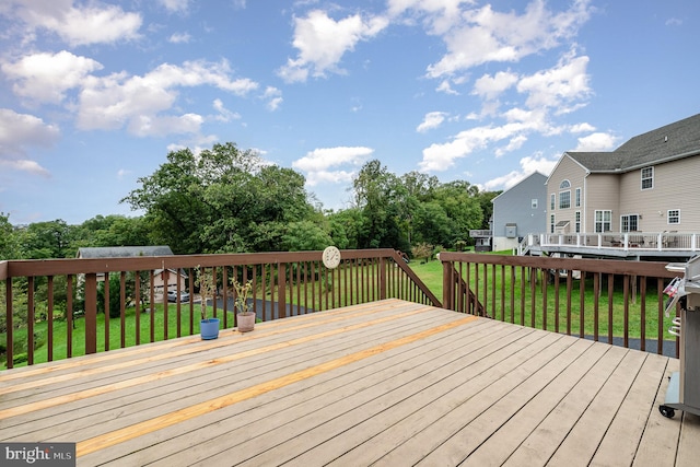 wooden deck with a lawn