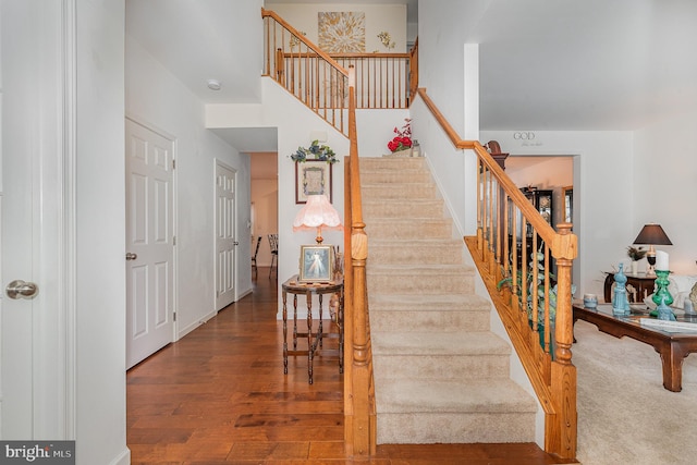 stairs with hardwood / wood-style floors