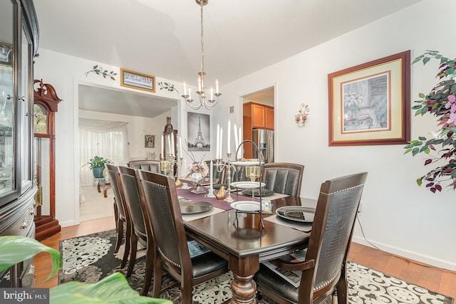 dining space featuring a chandelier and hardwood / wood-style flooring