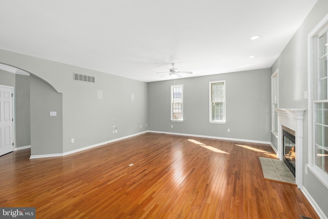 unfurnished living room with ceiling fan and wood-type flooring