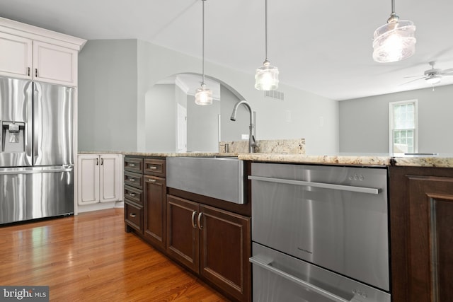 kitchen featuring white cabinetry, ceiling fan, hanging light fixtures, and appliances with stainless steel finishes