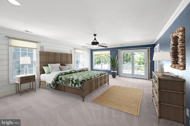 carpeted bedroom featuring access to exterior, ceiling fan, and crown molding