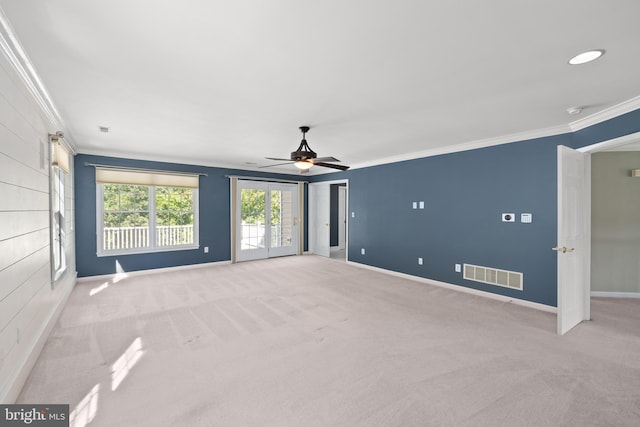 empty room featuring light colored carpet, ceiling fan, and ornamental molding