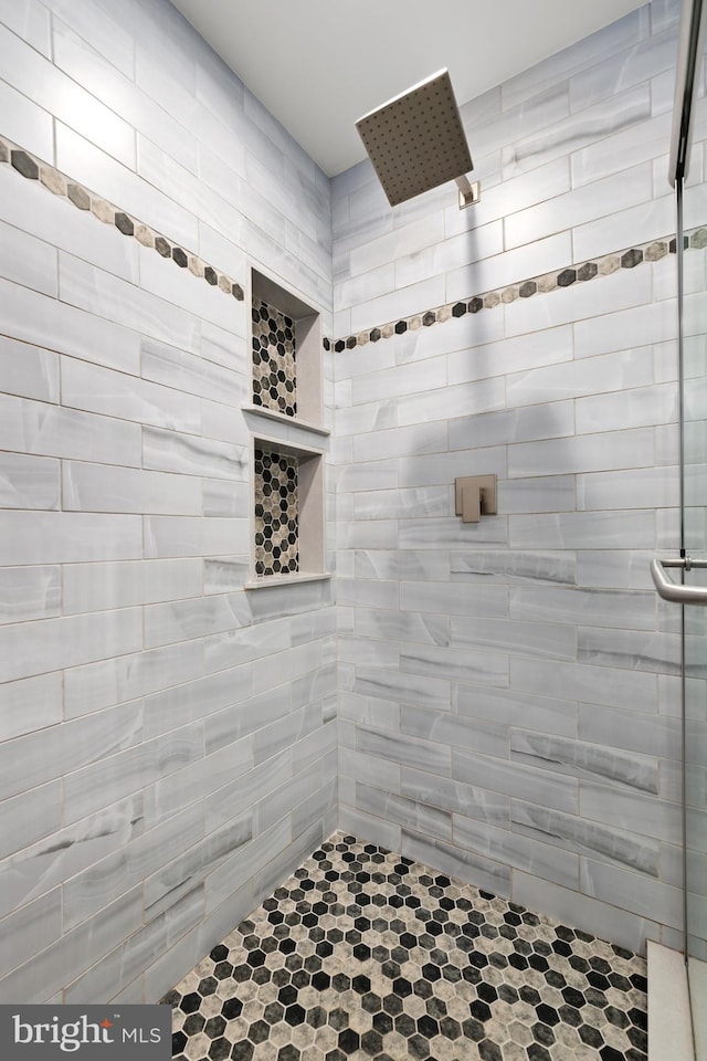 bathroom with a tile shower