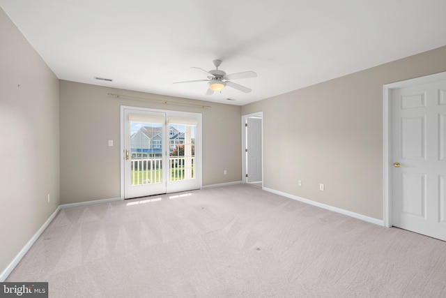 empty room with ceiling fan and light colored carpet