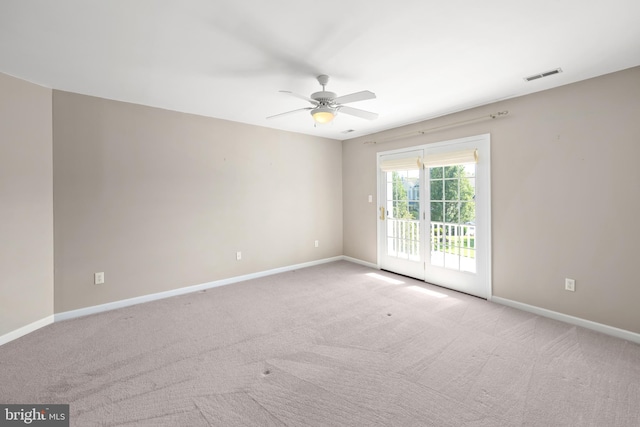 unfurnished room featuring ceiling fan and light carpet