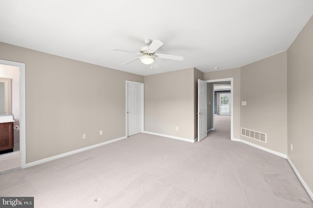 carpeted spare room with ceiling fan