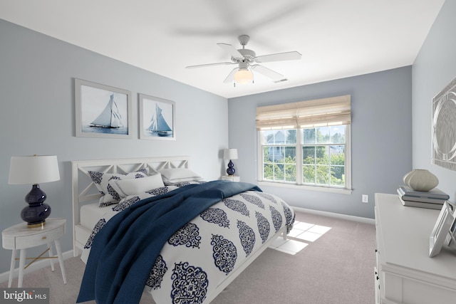 bedroom with ceiling fan and light carpet