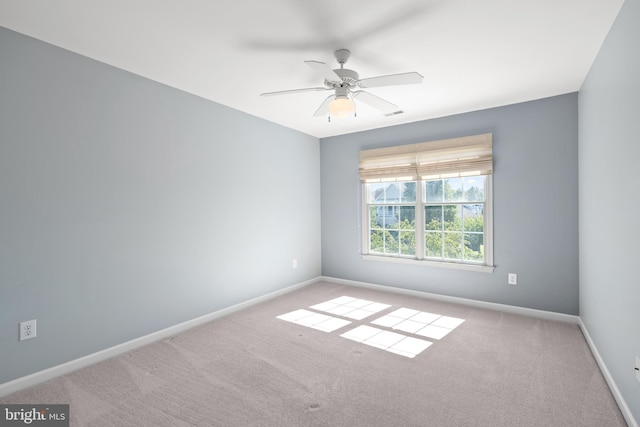 carpeted empty room featuring ceiling fan