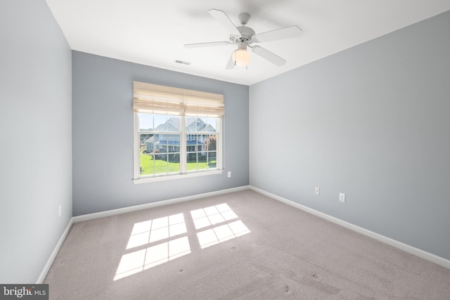 carpeted empty room featuring ceiling fan