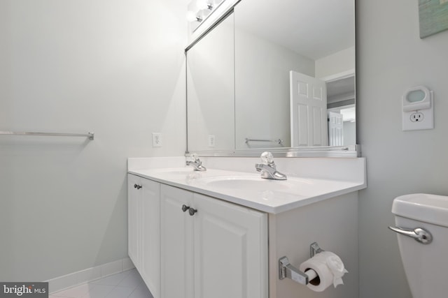 bathroom featuring tile patterned floors, vanity, and toilet