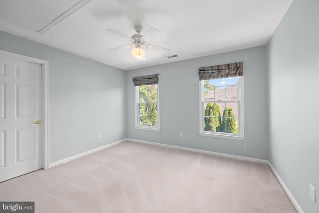 unfurnished room featuring light colored carpet and ceiling fan