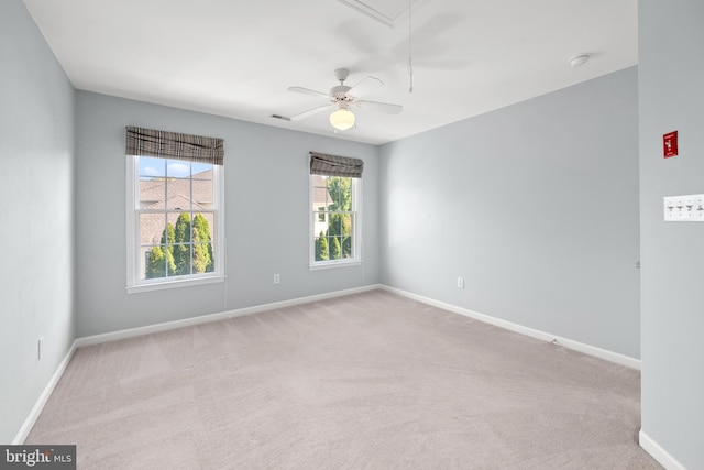 empty room featuring light carpet and ceiling fan