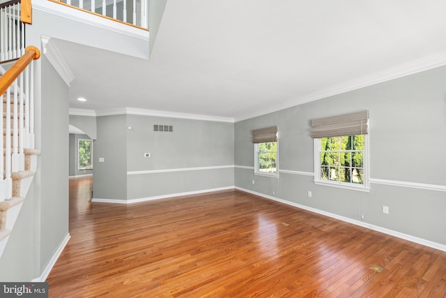 spare room with wood-type flooring and ornamental molding